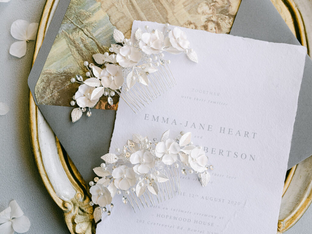 The White Collection bridal hair accessory on a wedding invitation